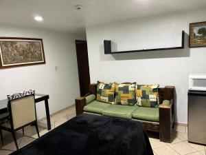 a living room with a couch and a table at Residencia Sofía in Casa Blanca La Corregidora