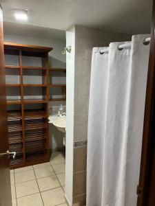 a bathroom with a shower curtain and a sink at Residencia Sofía in Casa Blanca La Corregidora
