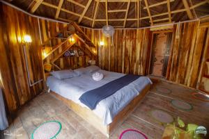 a bedroom with a large bed in a wooden room at Iraboti Eco Resort Sundarban in Dhāngmāri Forest Office
