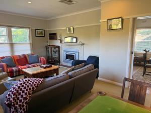 a living room with a couch and a fireplace at Namoi Dreaming Spacious parkview residence in Narrabri