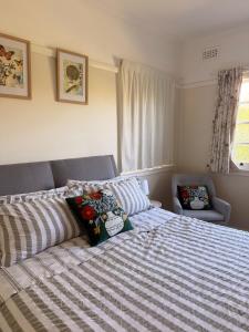 a bed with two pillows on it in a bedroom at Namoi Dreaming Spacious parkview residence in Narrabri