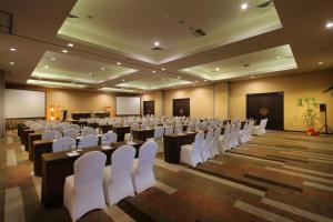 a large room with rows of tables and white chairs at b Hotel Bali & Spa in Denpasar +62 photos