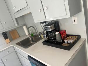 a kitchen counter with a sink and a coffeemaker at Walnuts in Owings Mills