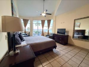 a bedroom with a bed and a lamp and a television at Hotel Marina Loreto in Loreto