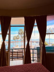 a bedroom with a bed and a view of the ocean at Hotel Marina Loreto in Loreto