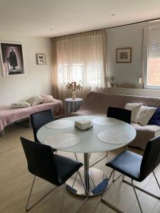 a living room with a couch and a table and chairs at Christina in Nieuwpoort