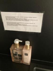 two bottles of soap and a sign on a wall at Christina in Nieuwpoort