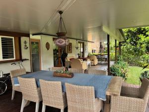 a dining room with a blue table and chairs at The Sanctuary on William - Nature Reserve Hideaway in Ormiston +16 photos