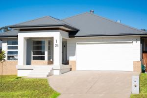 a house with a white garage at Huntlee Haven Luxe in North Rothbury