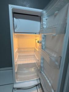 an empty refrigerator with its door open in a kitchen at Apartmento-Studio in União da Vitória