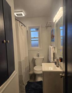 a bathroom with a toilet and a sink and a window at 2BR House Perfect for Olympic NP Adventures in Port Angeles