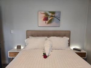 a bed with a white blanket and flowers on it at 2BR House Perfect for Olympic NP Adventures in Port Angeles