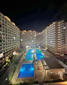 a view of a building with a pool at night at Saekyung Condominium in Suba