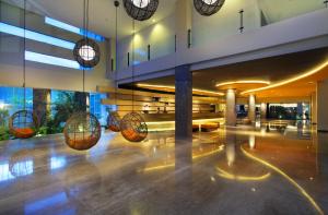 a lobby of a building with several balls on the floor at b Hotel Bali & Spa in Denpasar