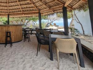 a restaurant with a table and chairs on the beach at Safira Resort in Santa Fe +41 photos