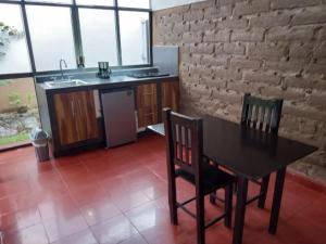 a kitchen with a table and chairs and a sink at Hotel Casa Capadose in Tlayacapan +17 photos
