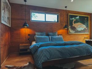 a bedroom with a bed and a picture of a dinosaur at The Little Seed in Franklin