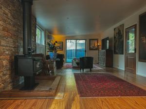 a living room with a tv and a brick wall at The Little Seed in Franklin