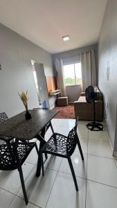 a living room with a table and chairs and a couch at Apartamento mobiliado in Marabá