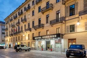 two jeeps parked in front of a building at Hotel Concord in Turin
