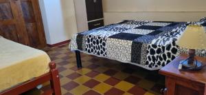 a bedroom with a bed and a table with a lamp at Casa-Rancho Grande in Santa María +8 photos