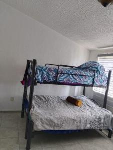 a bedroom with two bunk beds in a room at Casa de Mar in Acapulco +10 photos