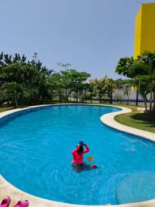 a person in a pool with a frisbee at Casa de Mar in Acapulco