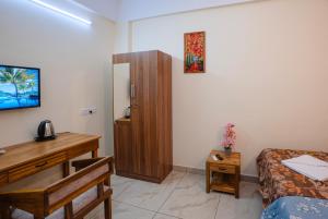 a room with a bedroom with a desk and a bed at Park View Residency - Guest House Near Sree Padmanabhaswamy Temple in Trivandrum