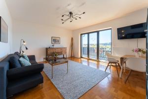 a living room with a couch and a table at Ferienwohnung Aribo in Seeon-Seebruck