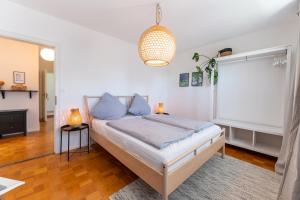 a bedroom with a bed and a pendant light at Ferienwohnung Aribo in Seeon-Seebruck