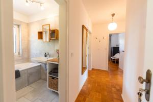 a bathroom with a tub and a sink and a bath tub at Ferienwohnung Aribo in Seeon-Seebruck +11 photos