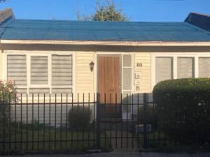 a small house with a fence in front of it at Casas Rabad in Punta Arenas