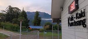 a sign on a building with a view of a mountain at K2K Studio Homestay in Ranau