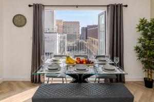 a dining room with a table with a bowl of fruit at Luxe By The Sea - Luxury in the Centre of Brighton - Aparthotel - 3 Beautiful Apartments - Penthouse Available in Brighton & Hove +53 photos