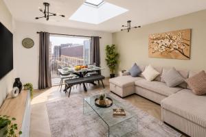 a living room with a couch and a table at Luxe By The Sea - Luxury in the Centre of Brighton - Aparthotel - 3 Beautiful Apartments - Penthouse Available in Brighton & Hove