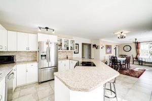 a kitchen with white cabinets and a counter top at Butterfly Manor in Niagara Falls