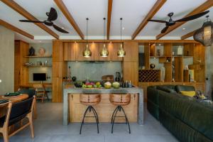 a kitchen and living room with a table and a couch at San Michele Villa in Dalung