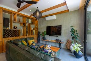 a living room with a couch and a tv at San Michele Villa in Dalung
