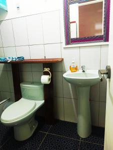 a bathroom with a toilet and a sink at Shekina Huaraz Departament in Huaraz +8 photos