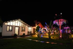 a house with christmas lights in the night at Eden Park Resorts in Vuyyūru