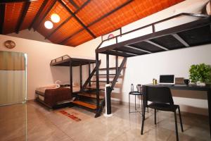 a room with a bunk bed and a desk with a laptop at Eden Park Resorts in Vuyyūru
