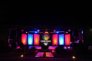a bear park sign on a stage at night at Eden Park Resorts in Vuyyūru