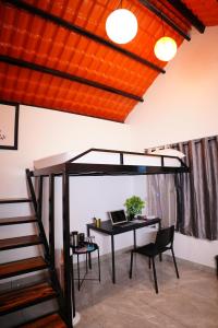 an office with a loft bed and a desk with a laptop at Eden Park Resorts in Vuyyūru +5 photos
