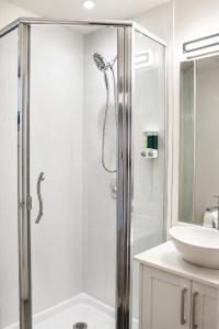a bathroom with a shower and a sink at Centrally Located Modern Suite in North Vancouver +29 photos
