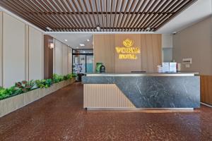 a lobby with a vaughan hotel sign on the wall at Vorya Hotel Danang Beach in Danang