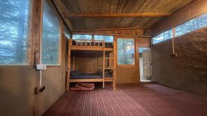 a small room with a bunk bed in a house at Alex Tribe Cafe and Funstay in Sainj