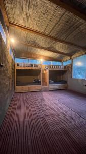 a large room with a wooden ceiling and wooden floors at Alex Tribe Cafe and Funstay in Sainj