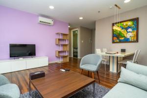 a living room with a couch and a table at Becamex Hotel Thu Dau Mot in Thu Dau Mot