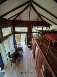 an attic room with a bed and a living room at Cabaña Vista de Oro 1 in Paraíso +24 photos
