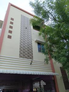 a building with a window on the side of it at Vihaasam Homestay in Thanjāvūr +2 photos